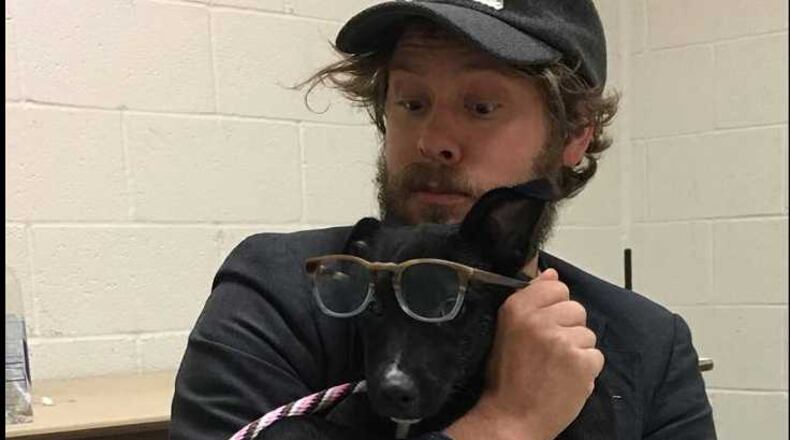 Wesley Schultz of The Lumineers cuddles with a dog at the Georgia SCPA in Suwanee.