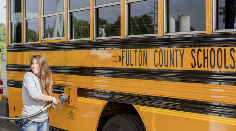 Julie Alighieri, a Fulton County school bus driver, fuels up at a propane filling station at the school district bus yard in Alpharetta.