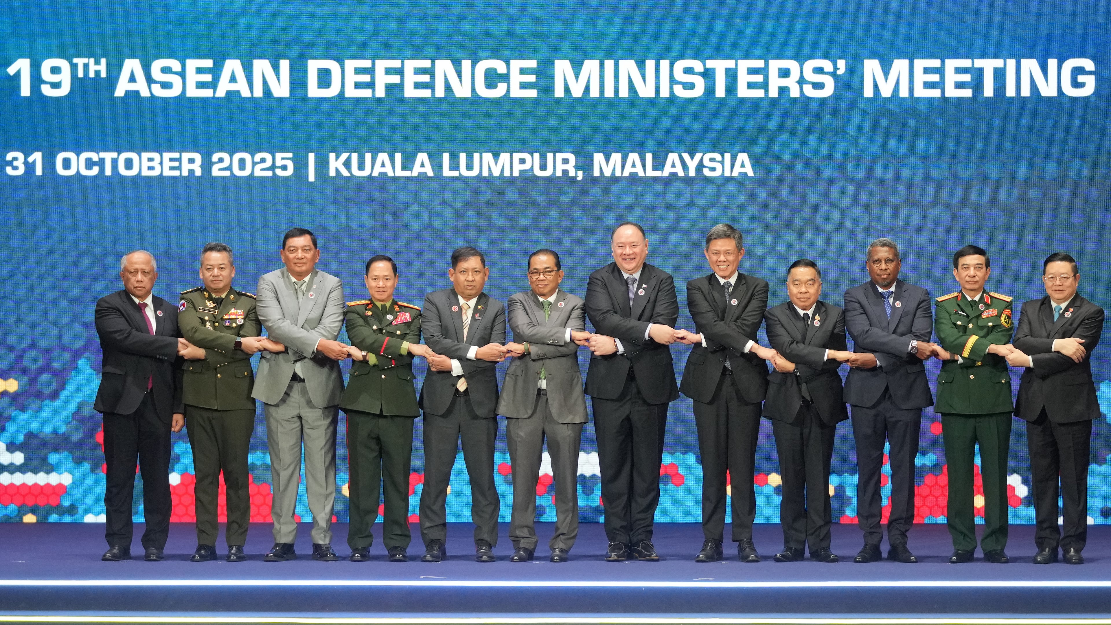 From left, Brunei's Defense Minister Halbi bin Haji Mohd Yussof, Cambodia's Defense Minister Tea Seiha, Indonesia's Defense Minister Sjafrie Sjamsoeddin, Laos' Defense Minister Khamlieng Outhakaisone, Myanmar's Permanent Secretary of the Ministry of Foreign Affairs Aung Kyaw Moe, Malaysia's Defense Minister Mohamed Khaled Nordin, Philippine's Defense Secretary Gilberto Teodoro, Singapore's Defense Minister Chan Chun Sing, Thailand's Defense Minister Natthaphon Narkphanit, East Timor's Defense Minister Donaciano da Costa Gomes, Vietnam's Defense Minister Phan Van Giang, and ASEAN Secretary-General Kao Kim Hourn hold hands as they pose for a group photo during the opening session of the Association of Southeast Asian Nations (ASEAN) Defense Ministers' Meeting in Kuala Lumpur, Malaysia, Friday, Oct. 31, 2025. (AP Photo/Dita Alangkara, Pool)