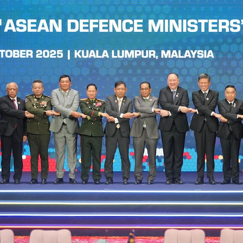 From left, Brunei's Defense Minister Halbi bin Haji Mohd Yussof, Cambodia's Defense Minister Tea Seiha, Indonesia's Defense Minister Sjafrie Sjamsoeddin, Laos' Defense Minister Khamlieng Outhakaisone, Myanmar's Permanent Secretary of the Ministry of Foreign Affairs Aung Kyaw Moe, Malaysia's Defense Minister Mohamed Khaled Nordin, Philippine's Defense Secretary Gilberto Teodoro, Singapore's Defense Minister Chan Chun Sing, Thailand's Defense Minister Natthaphon Narkphanit, East Timor's Defense Minister Donaciano da Costa Gomes, Vietnam's Defense Minister Phan Van Giang, and ASEAN Secretary-General Kao Kim Hourn hold hands as they pose for a group photo during the opening session of the Association of Southeast Asian Nations (ASEAN) Defense Ministers' Meeting in Kuala Lumpur, Malaysia, Friday, Oct. 31, 2025. (AP Photo/Dita Alangkara, Pool)