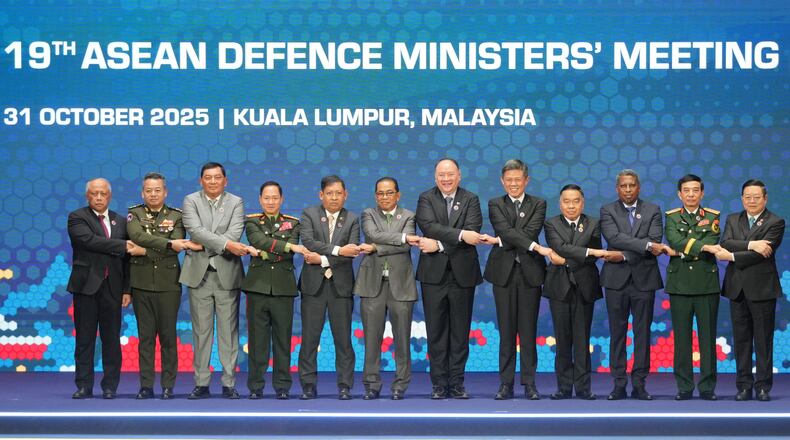From left, Brunei's Defense Minister Halbi bin Haji Mohd Yussof, Cambodia's Defense Minister Tea Seiha, Indonesia's Defense Minister Sjafrie Sjamsoeddin, Laos' Defense Minister Khamlieng Outhakaisone, Myanmar's Permanent Secretary of the Ministry of Foreign Affairs Aung Kyaw Moe, Malaysia's Defense Minister Mohamed Khaled Nordin, Philippine's Defense Secretary Gilberto Teodoro, Singapore's Defense Minister Chan Chun Sing, Thailand's Defense Minister Natthaphon Narkphanit, East Timor's Defense Minister Donaciano da Costa Gomes, Vietnam's Defense Minister Phan Van Giang, and ASEAN Secretary-General Kao Kim Hourn hold hands as they pose for a group photo during the opening session of the Association of Southeast Asian Nations (ASEAN) Defense Ministers' Meeting in Kuala Lumpur, Malaysia, Friday, Oct. 31, 2025. (AP Photo/Dita Alangkara, Pool)