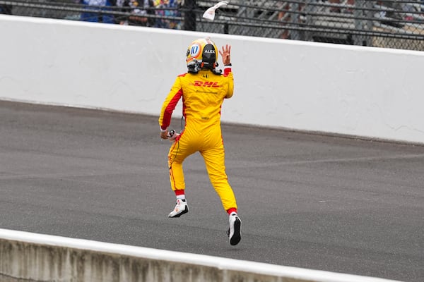 Alex Palou, of Spain, runs down the track as he celebrates after winning the Indianapolis 500 auto race at Indianapolis Motor Speedway in Indianapolis, Sunday, May 25, 2025. (AP Photo/Michael Conroy)