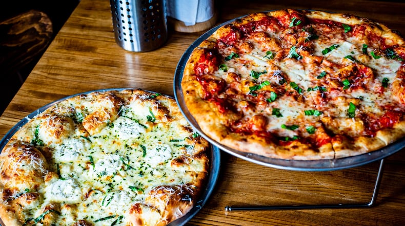 Two pizzas that show off the excellent ratio of sauce to toppings to crust at MTH Pizza are Bianca #5 (left) and the Margherita. CONTRIBUTED BY HENRI HOLLIS