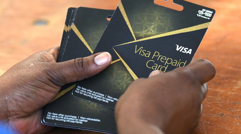DeKalb County gave out $100 prepaid debit cards to people who got the COVID-19 vaccine shot during an event at The Gallery at South DeKalb on Saturday, Aug. 14. (Hyosub Shin / Hyosub.Shin@ajc.com)