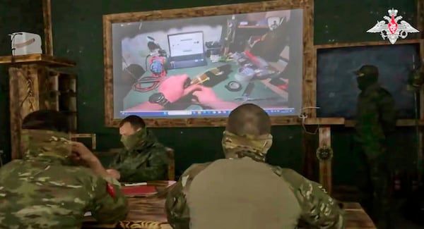 In this photo taken from video distributed by the Russian Defense Ministry Press Service on Monday, May 26, 2025, Russian serviceman train to work with military drones in an undisclosed location. (Russian Defense Ministry Press Service via AP)