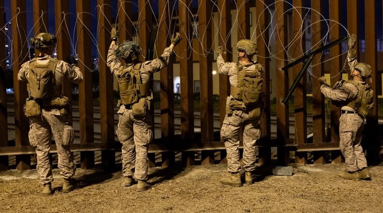 U.S. Marines with 1st Combat Engineer Battalion, 1st Marine Division, place concertina wire along the southern border near San Ysidro, California, on Jan. 25, 2025. (U.S. Marine Corps photo by Sgt. Kyle Chan)