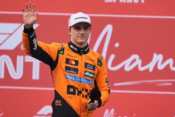 Second place finisher McLaren driver Oscar Piastri of Australia greets fan during a trophy ceremony after the Sprint race at the Formula One Miami Grand Prix auto race, Saturday, May 3, 2025, in Miami Gardens, Fla. (AP Photo/Rebecca Blackwell)