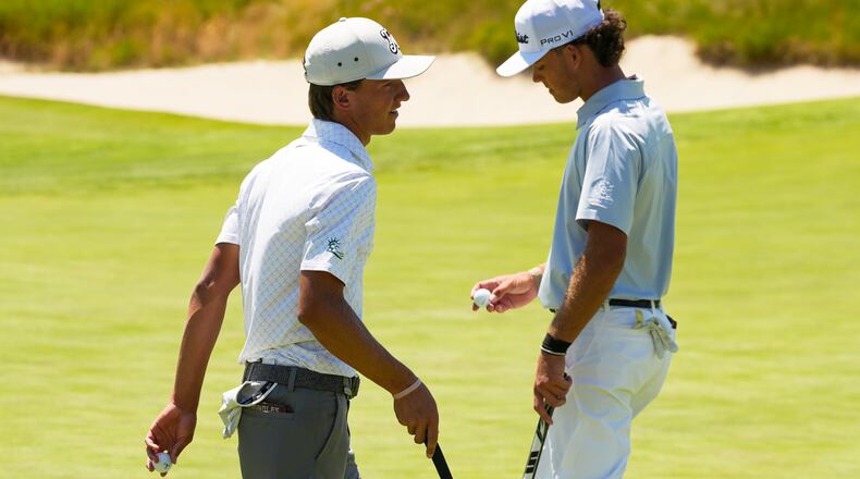 Miles Russell and Jackson Koivu walk on the 14th hole during the third round of the U.S. Open golf tournament at Shinnecock Hills Golf Club in Southampton, N.Y., Saturday, June 20, 2026.(AP Photo/Seth Wenig)