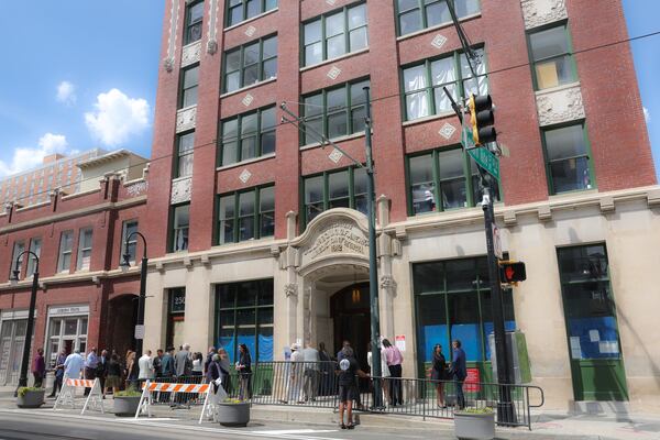People appear following a ribbon cutting for the opening of the affordable housing and transitional program run by Georgia Works in the Historic Odd Fellows building in Atlanta on April 1, 2026. (Arvin Temkar/AJC)