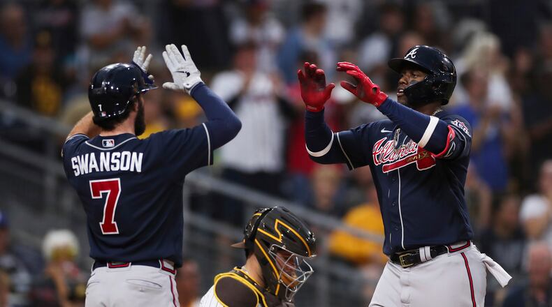 Braves' Jorge Soler, right, is congratulated by Dansby Swanson (7) after hitting a three-run home run against the San Diego Padres in the sixth inning of a baseball game Saturday, Sept. 25, 2021, in San Diego. (AP Photo/Derrick Tuskan)