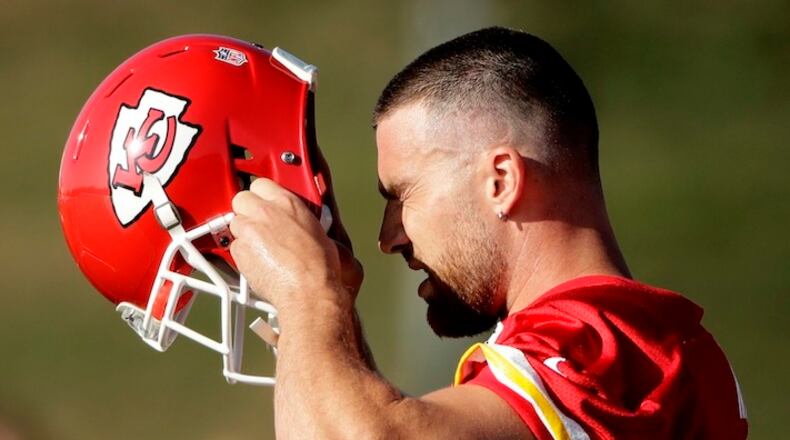 Kansas City Chiefs tight end Travis Kelce (87) puts on his helmet during NFL football training camp Saturday, July 29, 2017, in St. Joseph, Mo. (AP Photo/Charlie Riedel)