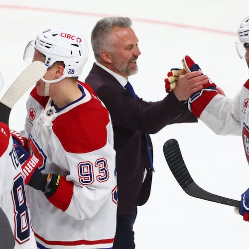 Montreal Canadiens head coach Martin St. Louis shakes hands with Montreal Canadiens center Alex Newhook (15) following the overtime period in Game 7 of a second-round NHL hockey Stanley Cup playoff series against the Buffalo Sabres, Monday, May 18, 2026, in Buffalo, N.Y. (AP Photo/Jeffrey T. Barnes)