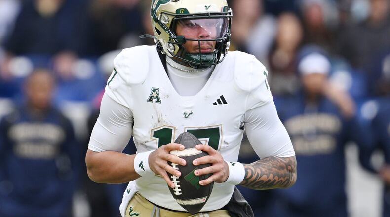 FILE - South Florida quarterback Byrum Brown (17) runs against Navy during the first half of a NCAA college football game, Saturday, Nov.15, 2025, in Annapolis, Md.(AP Photo/Gail Burton, File)