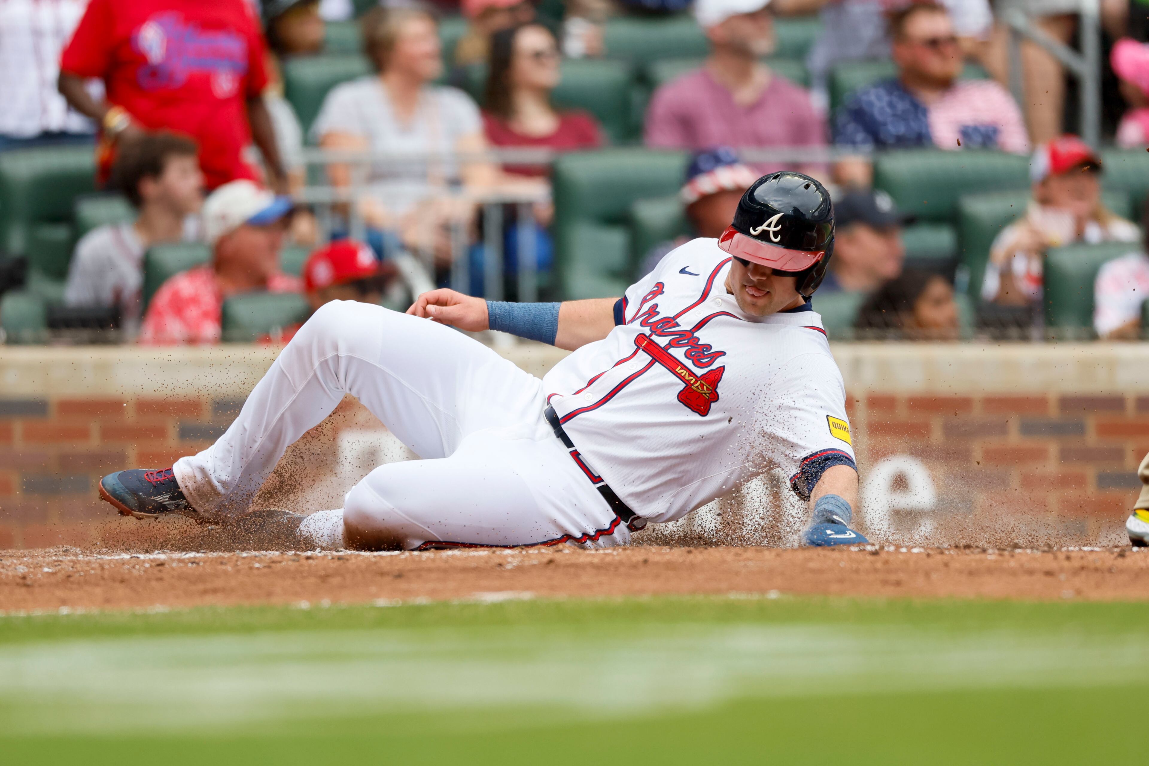 Atlanta Braves' Austin Riley (27) slides safe at home for the team's first run during the second inning of a baseball game against the San Diego Padres on Sunday, May 25, 2025, in Atlanta. (Miguel Martinez/Atlanta Journal-Constitution via AP)