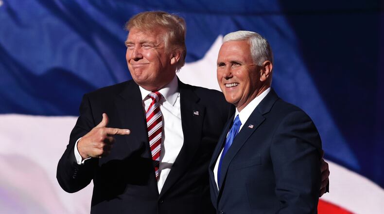 CLEVELAND, OH - JULY 20: Republican presidential candidate Donald Trump stands with Republican vice presidential candidate Mike Pence and acknowledge the crowd on the third day of the Republican National Convention on July 20, 2016 at the Quicken Loans Arena in Cleveland, Ohio. Republican presidential candidate Donald Trump received the number of votes needed to secure the party's nomination. An estimated 50,000 people are expected in Cleveland, including hundreds of protesters and members of the media. The four-day Republican National Convention kicked off on July 18. (Photo by Chip Somodevilla/Getty Images)