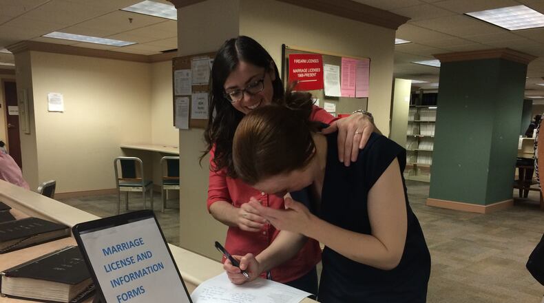 Monet Brewerton breaks down as she and her bride-to-be Sarah Ann Palmer fill out their marriage application. Greg Bluestein/AJC Photo.