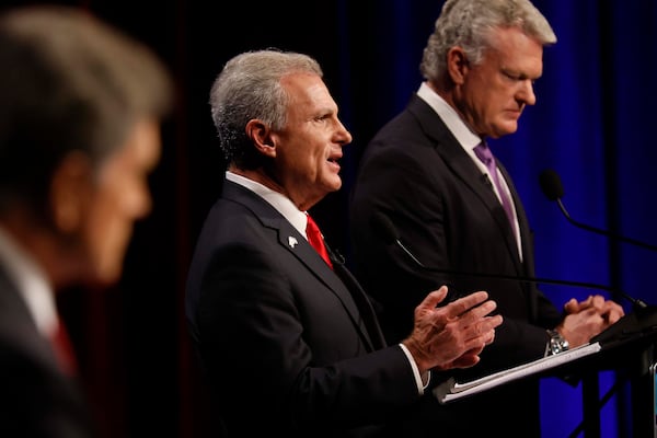 U.S. Rep. Buddy Carter, R-St. Simons Island, center, responds to a question from a panelist during the Atlanta Press Club Loudermilk-Young debate for the U.S. Senate at Georgia Public Broadcasting in Midtown on Sunday, April 26, 2026.  (Miguel Martinez/AJC)