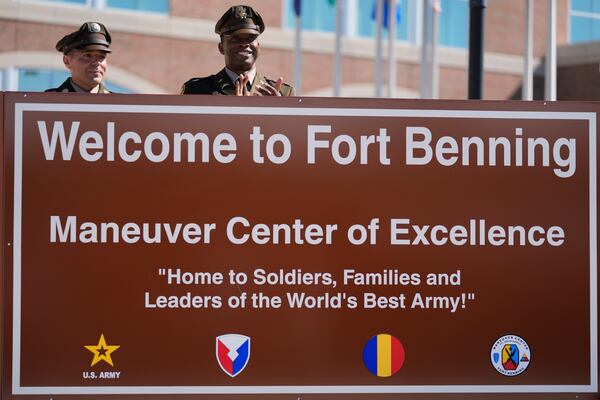Members of the Army military stand behind a new sign at Fort Benning during a ceremony honoring new namesake on Wednesday, April 16, 2025, in Fort Benning, Ga. (AP Photo/Brynn Anderson)