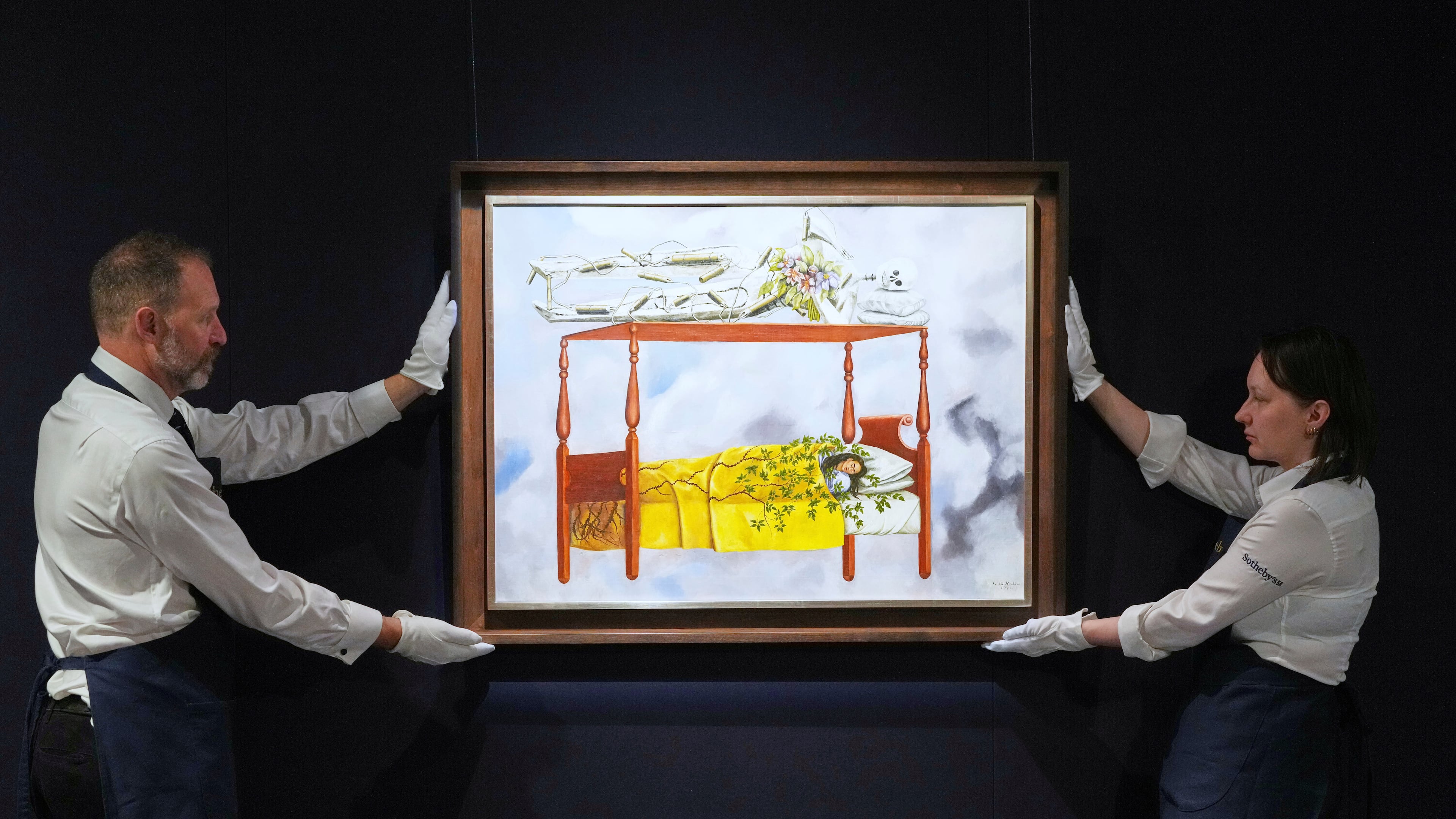 FILE - A painting by Frida Kahlo titled "El sueño (La cama)" or (The Dream (The Bed), is displayed at Sotheby's auction rooms in London, Sept. 19, 2025. The painting, estimated at 40-60 million US dollars, is part of a collection of surrealist masterpieces unveiled ahead of its upcoming sale in New York. (AP Photo/Kirsty Wigglesworth, File)