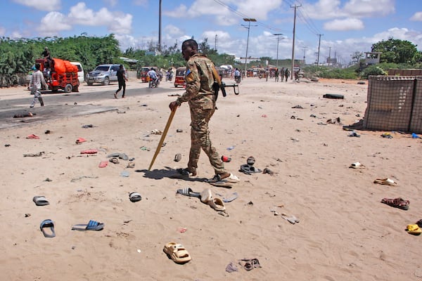 Security officer patrol near the scene of a suicide bomber attack in Mogadishu, Somalia Sunday, May 18, 2025. (AP Photo/Farah Abdi Warsameh)