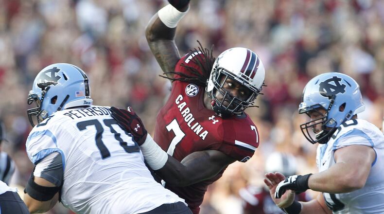 South Carolina defensive end Jadeveon Clowney (7) fights through a block by North Carolina offensive linesman Caleb Peterson (70) in the second quarter at Williams-Brice Stadium in Columbia, South Carolina, on Thursday, August 29, 2013.