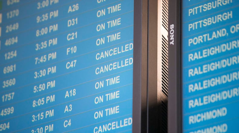 Canceled flights are displayed on an electronic screen inside the domestic terminal at Hartsfield-Jackson International Airport in Atlanta on Tuesday, April 14, 2020. (ALYSSA POINTER / ALYSSA.POINTER@AJC.COM)