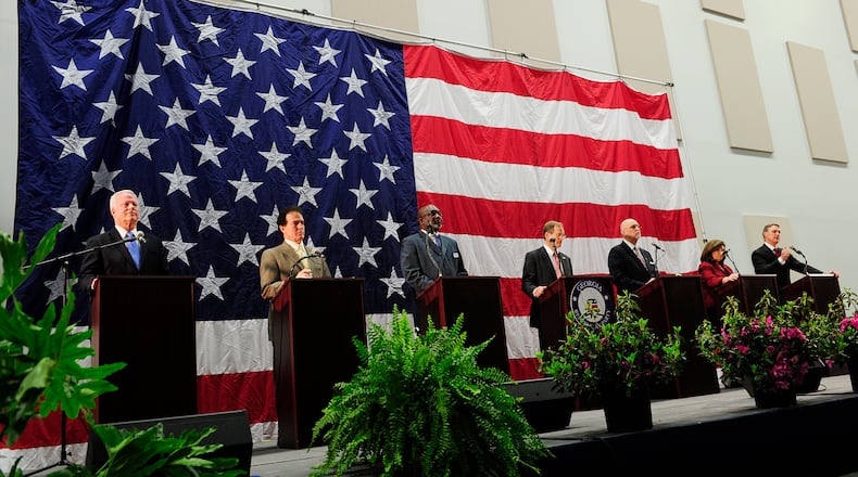 From left, Reps. Paul Broun and P.J. Gingrey, Minister Derrick Grayson, Rep. Jack Kingston, Arthur Gardner, Karen Handel, and David Perdue stand at their podiums near the end of the Georgia Republican Party U.S. Senate Debate at the Columbia County Exhibition Center in Grovetown, Ga. on Saturday, April 19, 2014. (AP Photo/The Augusta Chronicle, Sara Caldwell) From left, U.S. Reps. Paul Broun and Phil Gingrey, Derrick Grayson, Rep. Jack Kingston, Arthur Gardner, Karen Handel, and David Perdue stand at their podiums near the end of the state GOP’s U.S. Senate debate in Grovetown, Ga. on Saturday. AP/The Augusta Chronicle, Sara Caldwell