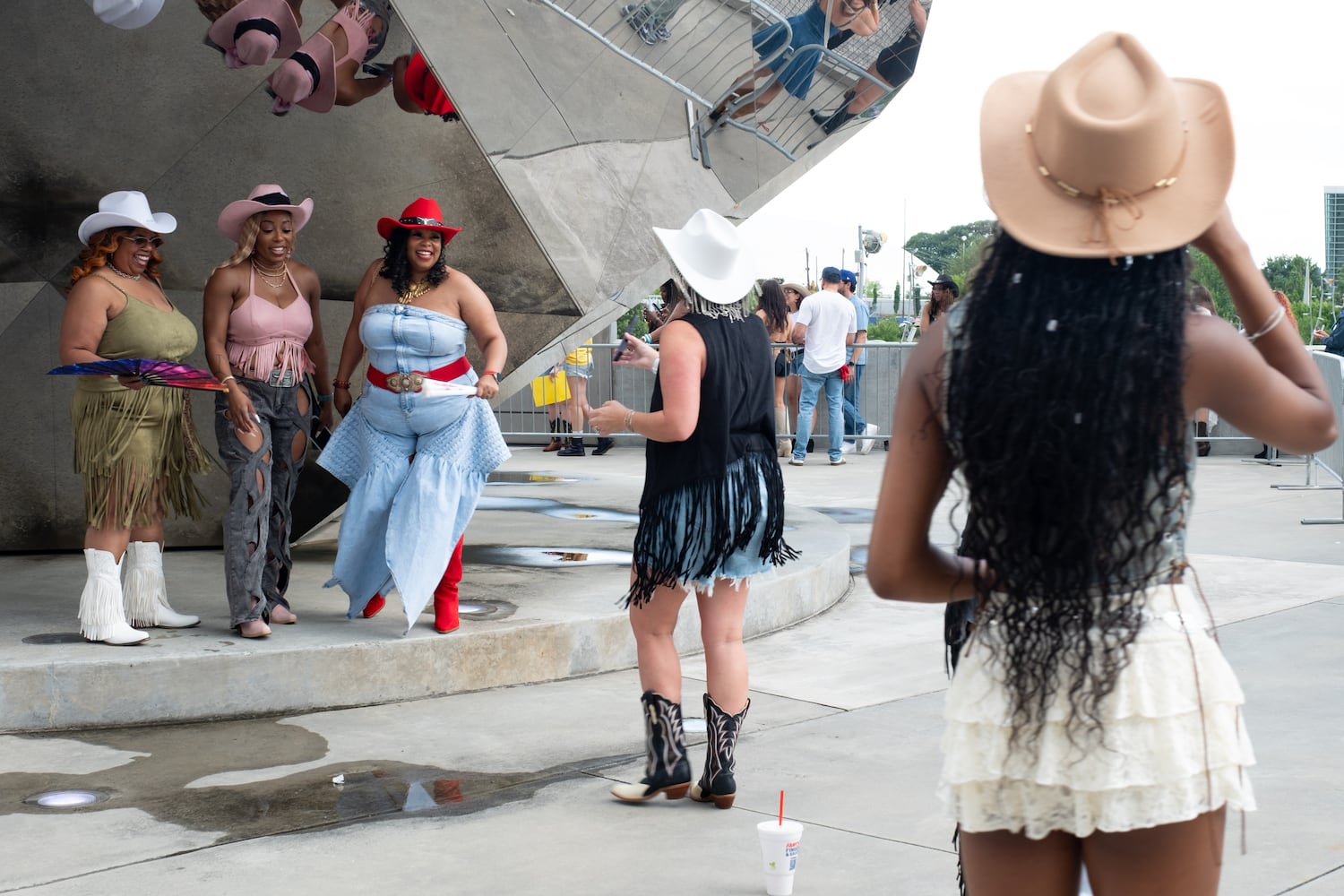 Reyna Burgess, from left, and her daughters Benishaa Burgess and Bre Savage pose for a photo before going into Mercedes-Benz Stadium for Beyoncè’s “Cowboy Carter” show Friday, July 11, 2025.   Ben Gray for the Atlanta Journal-Constitution