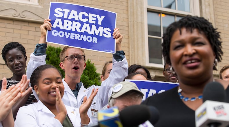 09/10/2018 -- Atlanta, Georgia -- Medical students cheer as Georgia Democratic Gubernatorial candidate Stacey Abrams is introduced to speak about her healthcare plan for Georgia outside of Grady Memorial Hospital in Atlanta, Monday, September 10, 2018. (ALYSSA POINTER/ALYSSA.POINTER@AJC.COM)