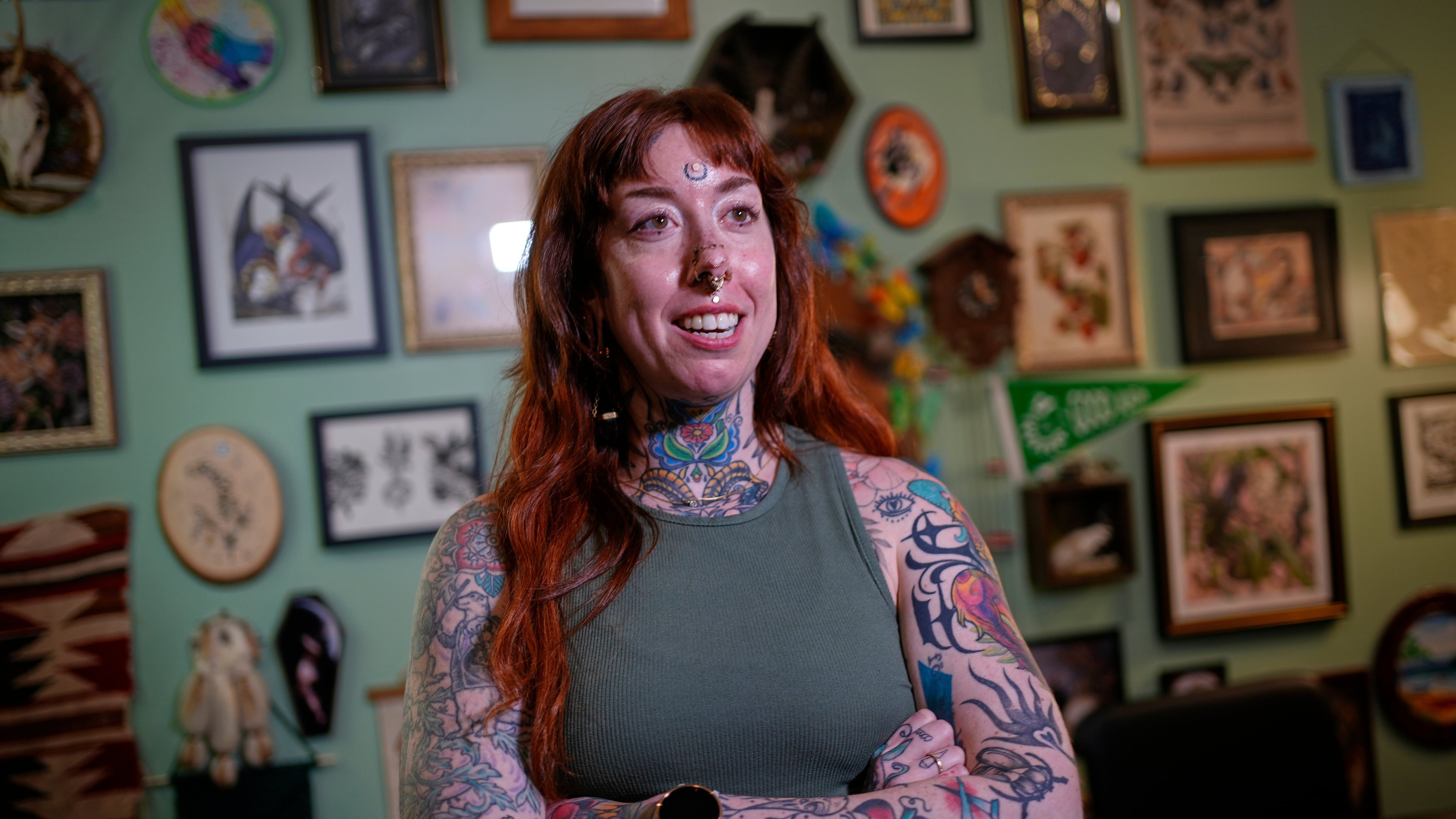 Tattoo artist Mischa Ostberg talks with a visitor at the Ghost Rose Tattoo parlor, Nov. 3, 2025, in Ellsworth, Maine. (AP Photo/Robert F. Bukaty)