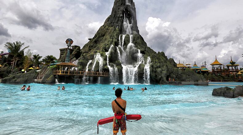 A lifeguard stands watch near the Krakatau volcano, the centerpiece water attraction at Universal Orlando's Volcano Bay. Federal investigators say the resort won't be cited for electrical problems that led to lifeguards getting shocked at its water park, saying the resort was unaware something was wrong. The report released this week said that five lifeguards reported receiving electric shocks last June at the Volcano Bay water park.