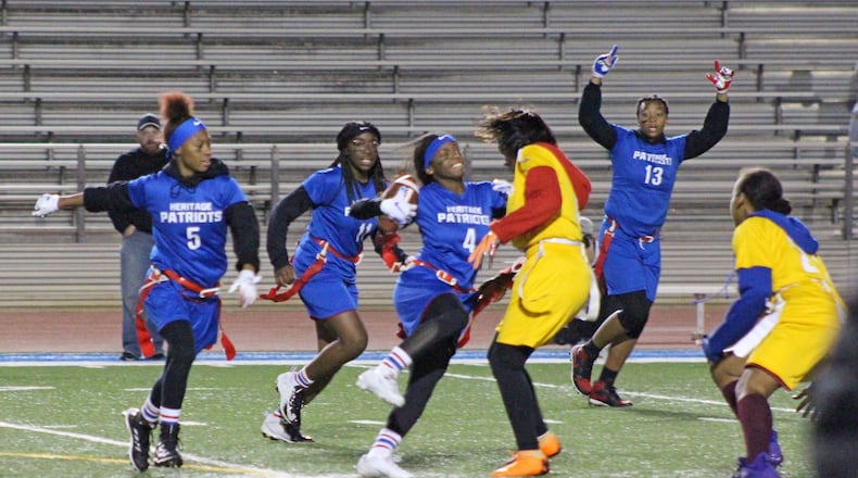 Heritage High’s Kristyn Goshay (4) is stopped in her attempt at a touchdown when a Salem High player pulls her flag, in  a flag game in Rockdale County in November.  COURTESY OF ROCKDALE COUNTY SCHOOLS