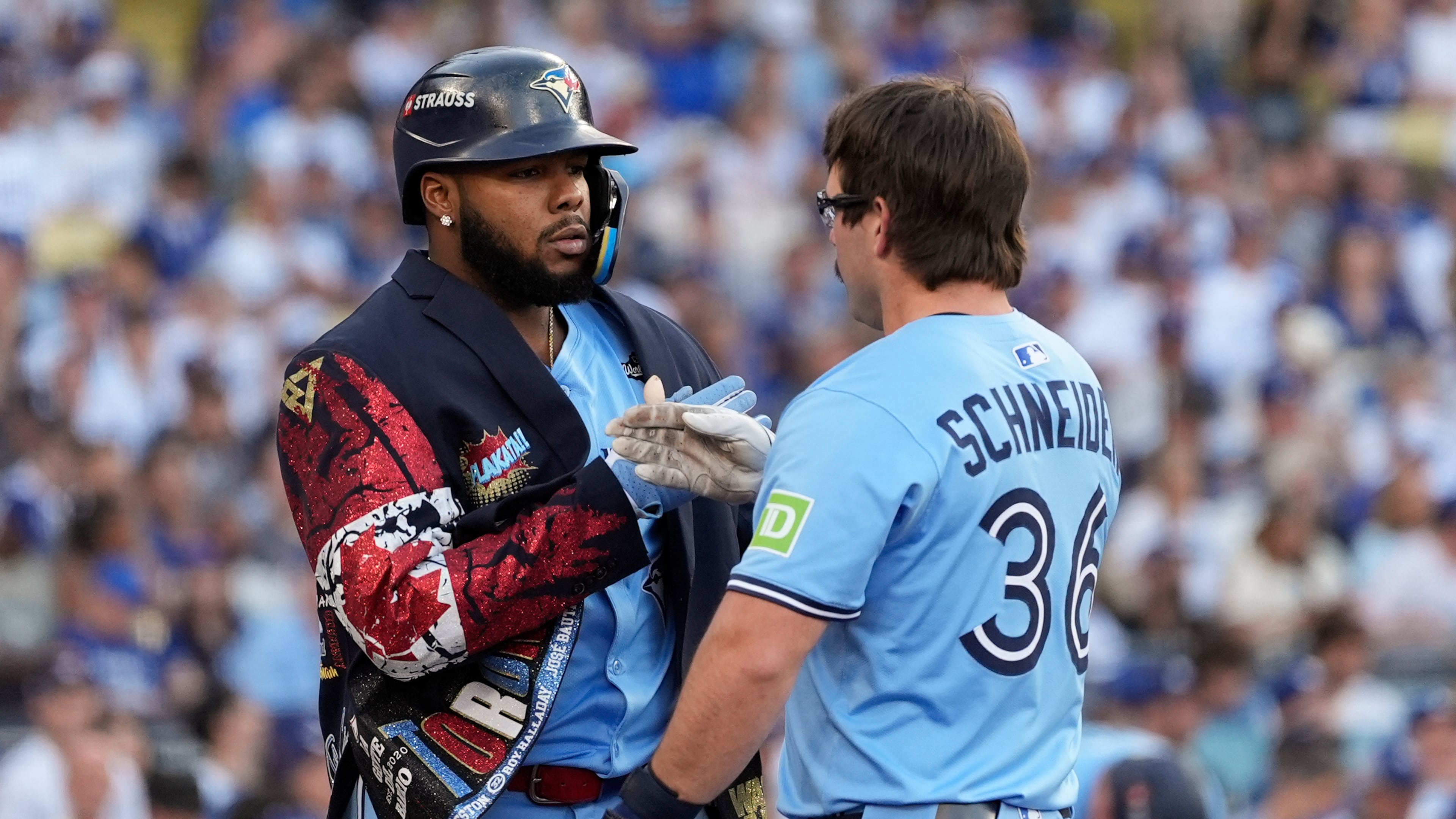 Toronto Blue Jays' Davis Schneider (36) celebrates with Vladimir Guerrero Jr. after their back-to-back home runs during the first inning in Game 5 of baseball's World Series against the Los Angeles Dodgers, Wednesday, Oct. 29, 2025, in Los Angeles. (AP Photo/Ashley Landis)