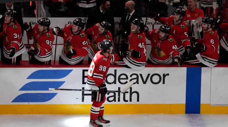 Chicago Blackhawks center Connor Bedard (98) celebrates his goal against the Calgary Flames during the third period of an NHL hockey game Tuesday, Nov. 18, 2025, in Chicago. (AP Photo/David Banks)