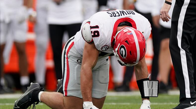 Georgia tight end Brock Bowers kneels on the turf after being injured in the first half of an NCAA college football game against Vanderbilt, Saturday, Oct. 14, 2023, in Nashville, Tenn. (AP Photo/George Walker IV)