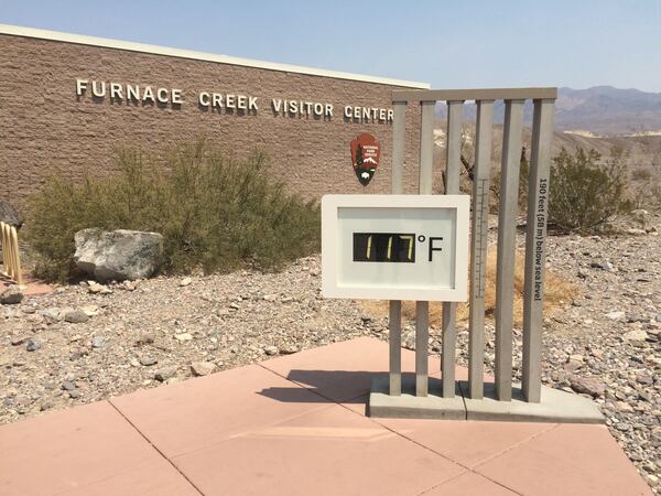 A thermometer reads 117 degrees outside of the Furnace Creek Visitor Center in California, a region notorious for hot weather and prized by automakers for hot-weather testing their cars. (Courtesy Matt Degen/Cox Automotive)