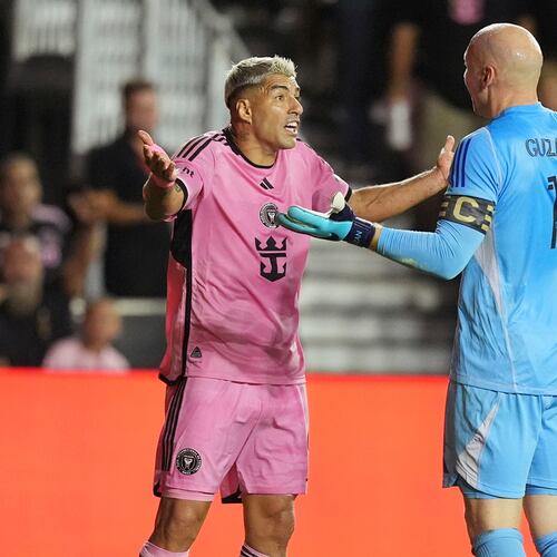 Atlanta United goalkeeper Brad Guzan (right) and Inter Miami star Luis Suarez discuss important things during a November playoff match in Fort Lauderdale.