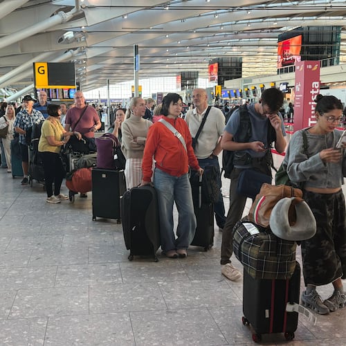 Passengers wait in line at Heathrow Airport in London, during an air traffic control problem that disrupted travel across Britain. (Jonathan Brady/PA via AP)