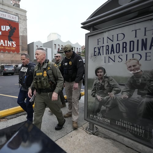 U.S. Border Patrol Commander at large Gregory Bovino, 3rd left, walks on the street in New Orleans, La.,Wednesday, Dec. 3, 2025. (AP Photo/Gerald Herbert)
