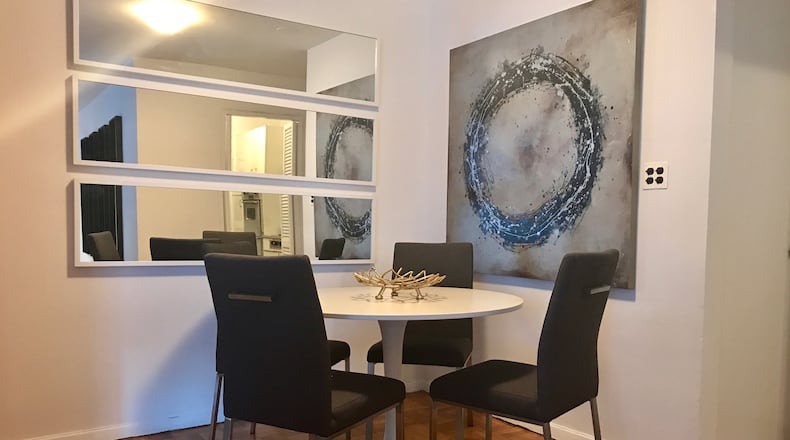 Three horizontal mirrors help to open a small dining area. (Design Recipes/TNS)