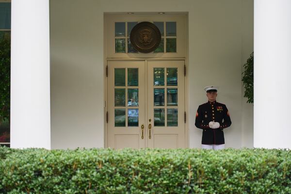 A U.S. Marine stands outside the entrance to the West Wing of the White House as President Donald Trump meets in the Situation Room, Tuesday, June 17, 2025, in Washington. (AP Photo/Evan Vucci)