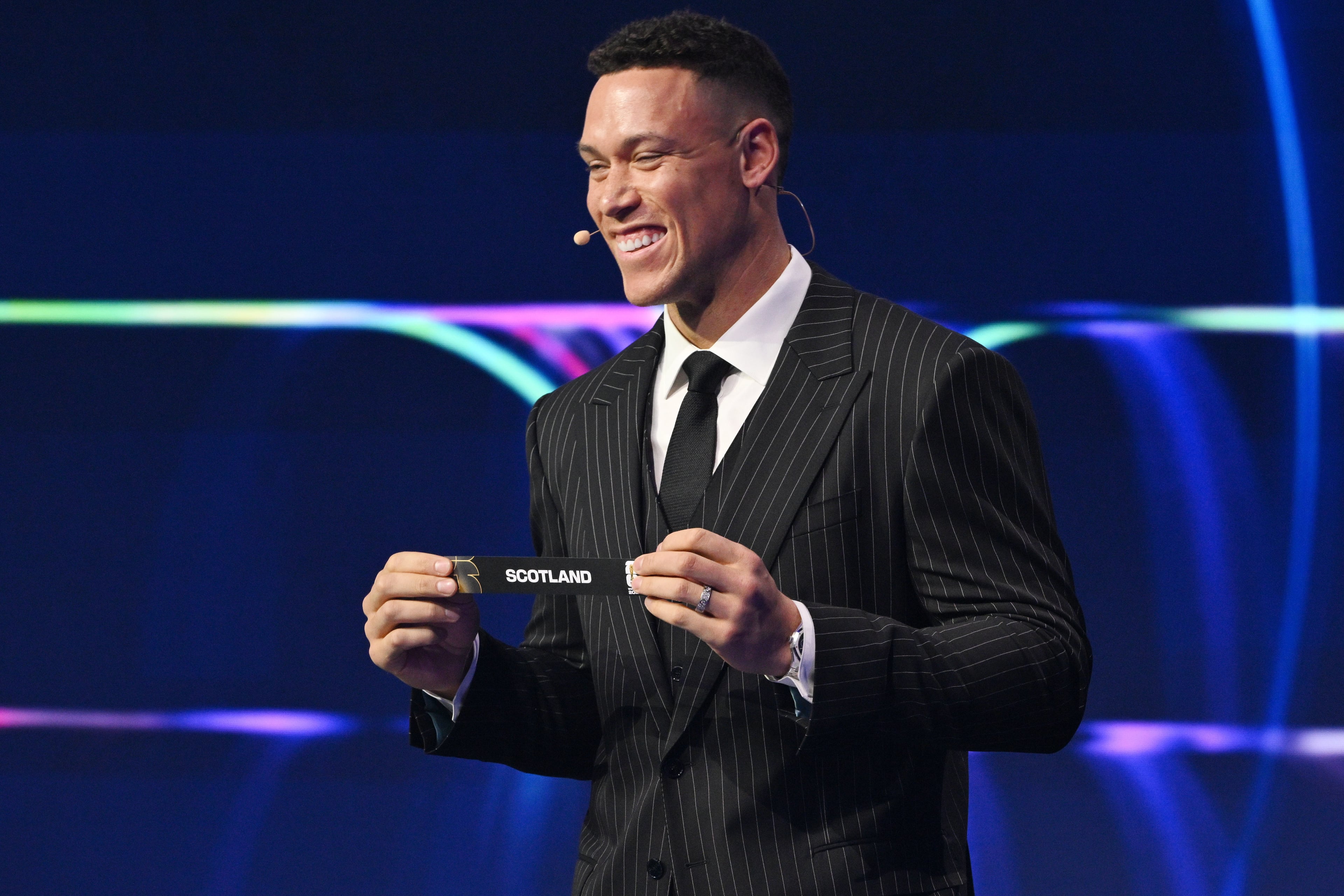 New York Yankees' Aaron Judge holds up Scotland after drawing from a pot during the draw for the 2026 soccer World Cup at the Kennedy Center in Washington, Friday, Dec. 5, 2025. (Mandel Ngan/Pool Photo via AP)