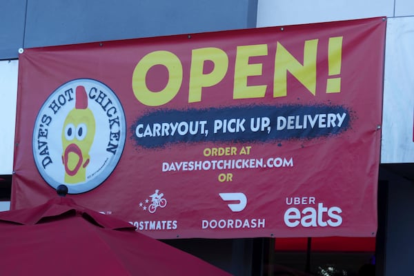 An open sign for Dave's Hot Chicken restaurant is seen in the Little Tokyo district of Los Angeles Monday, June 2, 2025. (AP Photo/Damian Dovarganes)