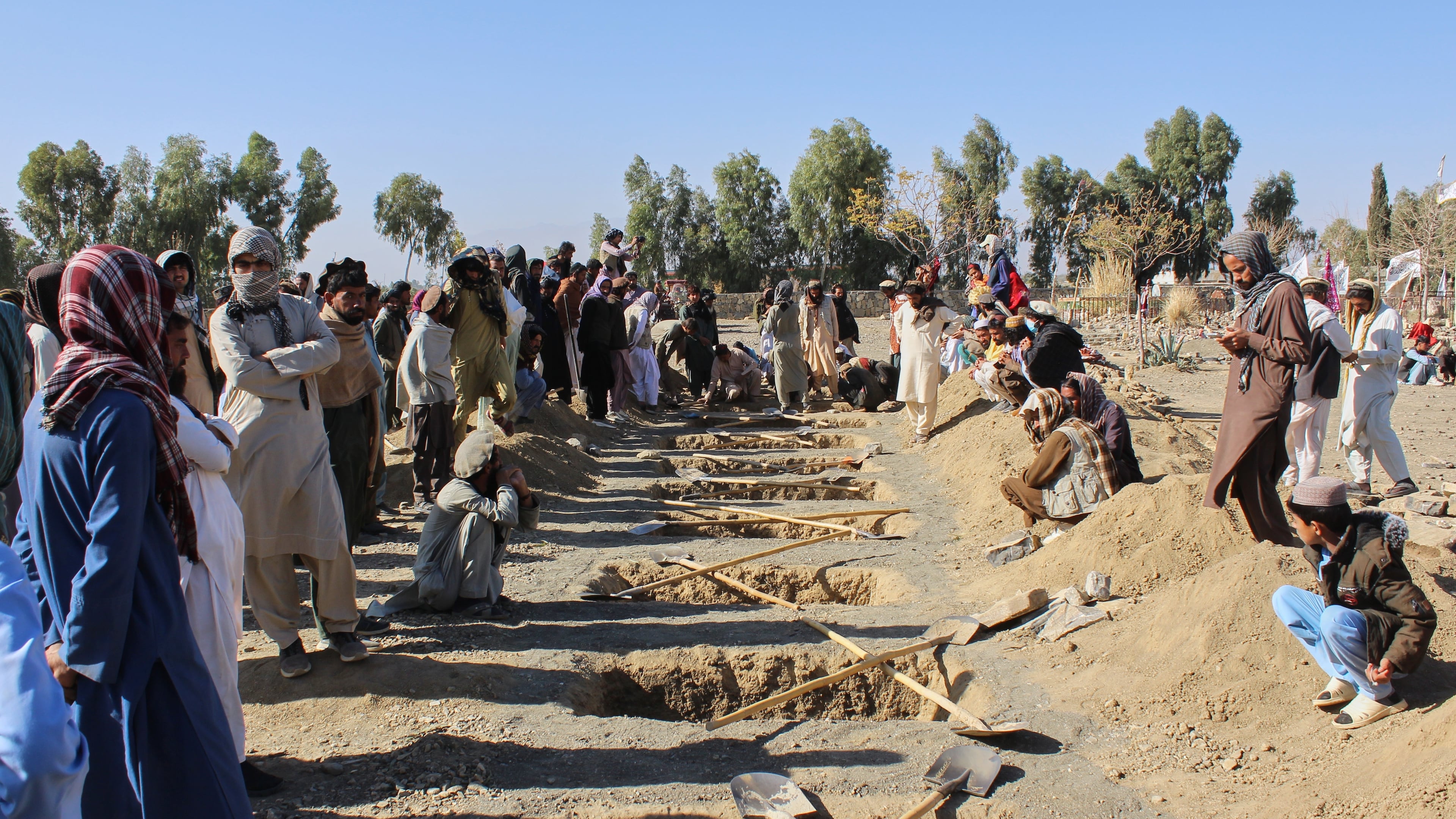 Locals prepare graves for victims of an overnight attack on a home that, according to an Afghan government spokesman, was carried out by Pakistan, in the Gurbaz district of Khost province, Afghanistan, Tuesday, Nov. 25, 2025. (AP Photo/Saifullah Zahir)