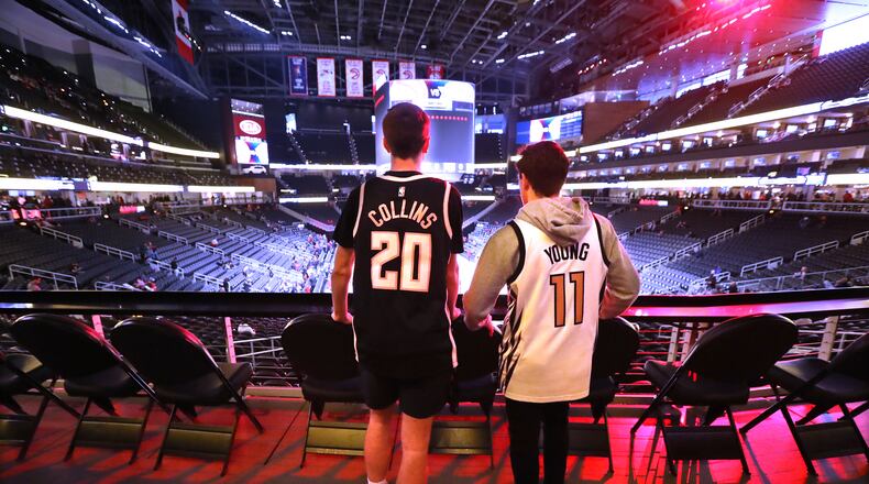 Hawks fans Robert Foushee (left), Woodstock, and Jon Cristofunelli (right), Alpharetta, are on hand to watch their team play the New York Knicks Wednesday, March 11, 2020, at State Farm Arena in Atlanta. The Hawks season ended when the NBA went on hiatus due to the coronavirus.   (Curtis Compton ccompton@ajc.com)