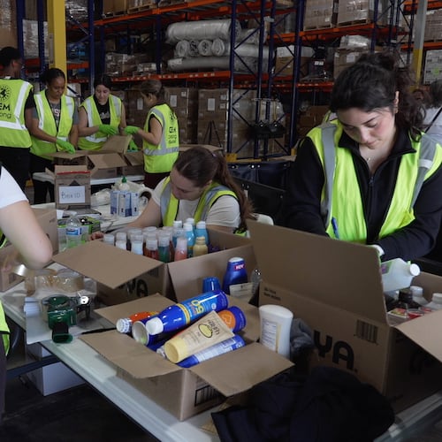 Volunteers are seen packaging supplies, Thursday, June 25, 2026, in Doral, Fla. (AP Photo/Cody Jackson)