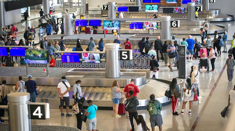 People wait for their luggage at Hartsfield-Jackson Atlanta International Airport Sunday, May 9, 2021. STEVE SCHAEFER FOR THE ATLANTA JOURNAL-CONSTITUTION