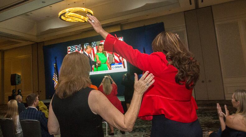 At a watch party for the GOP national convention, Georgia Republicans get excited as President Donald Trump approaches the stage to give his acceptance speech. Georgia Republicans have stepped up their voter outreach. Georgia GOP Executive Director Stewart Bragg says party staffers and volunteers in the state have made roughly 6 million voter contacts and knocked on 600,000 doors so far.  (Jenni Girtman for The Atlanta Journal-Constitution)