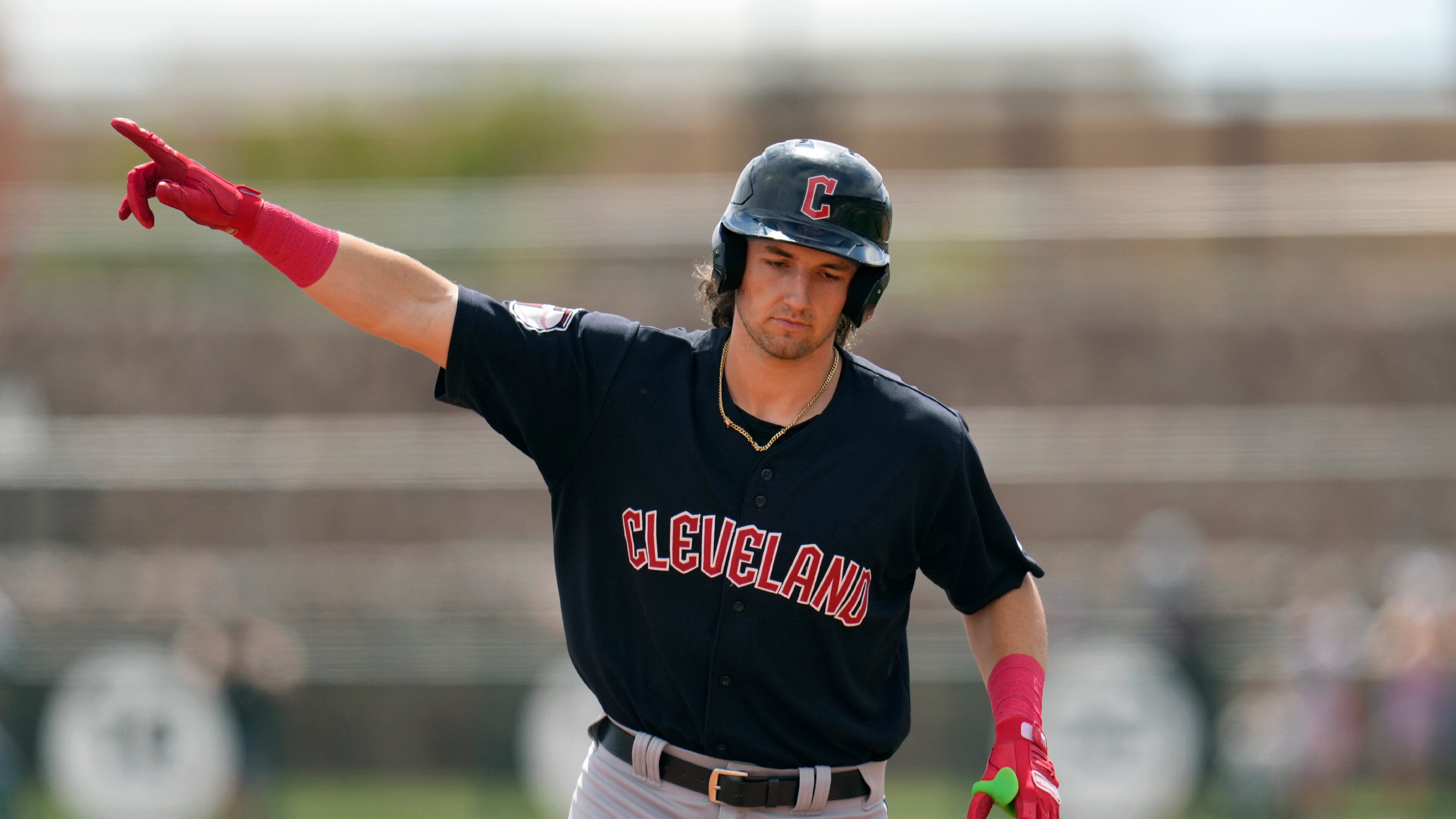 FILE - Cleveland Guardians' Chase DeLauter points as he rounds the bases after hitting a three-run home run against the Chicago White Sox during the first inning of a spring training baseball game, March 18, 2024, in Phoenix. (AP Photo/Ross D. Franklin, file)