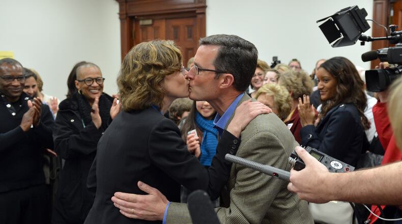 March 6, 2014 Atlanta: U.S. Senate candidate Michelle Nunn, daughter of former U.S. Senator Sam Nunn, gets a kiss from her husband, Ron Martin, after officially signing up to run for office Thursday March 6, 2014. BRANT SANDERLIN /BSANDERLIN@AJC.COM